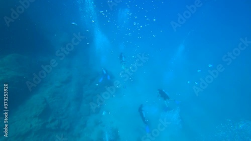 Fethiye, Turkey - 30th of July 2020: 4K Plenty of small air bubbles rise up from the scuba divers at the deeps
