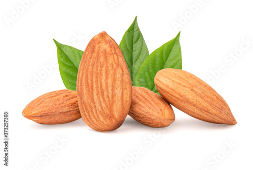 Closeup isolated of fresh almonds nut seed with green leaves on white background.