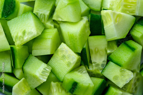 ingredient for salad. close-up view of dice of Cucumber, diced Cucumber background. Macro view of vegetable texture