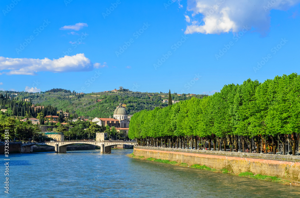 Fototapeta premium Verona Embankment of the Adige River view of the Garibaldi Bridge and Campanile San Giorgio in Braida. Italy