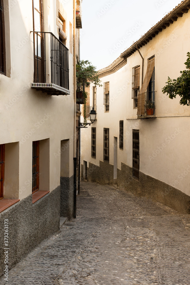 Cozy empty street in city center of Granada Spain summer evening