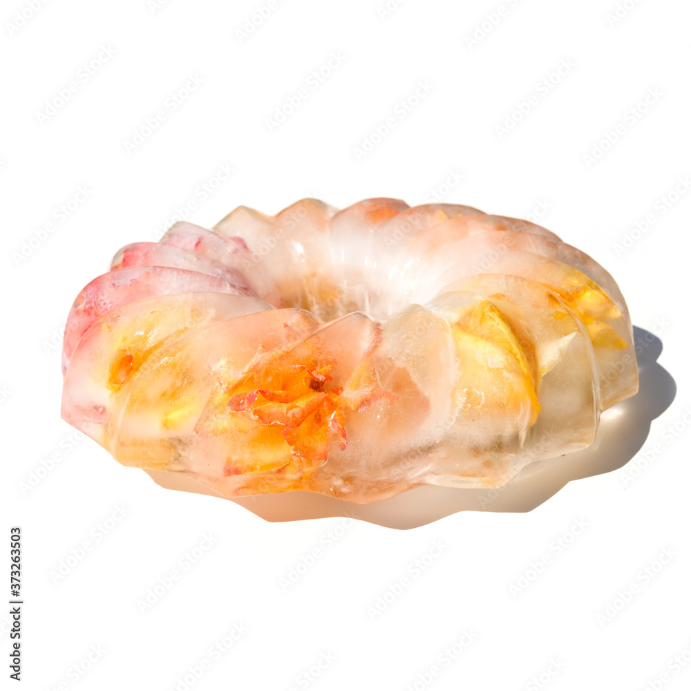 Frozen flowers trapped in a block of ice of shape cake. Roses in ice. Frozen flowers trapped in a block of ice of shape cake. Roses in ice.