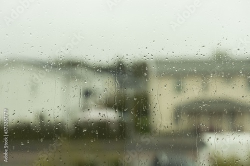 View of raindrops running on window glass. Beautiful nature backgrounds.