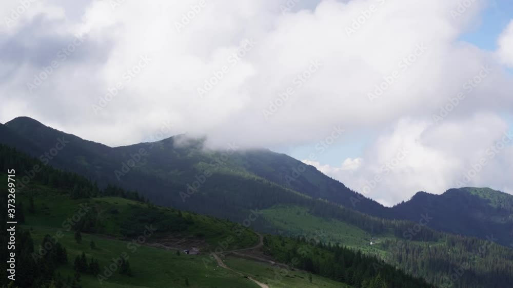 Timelapse mountain top in fog white clouds blue sky