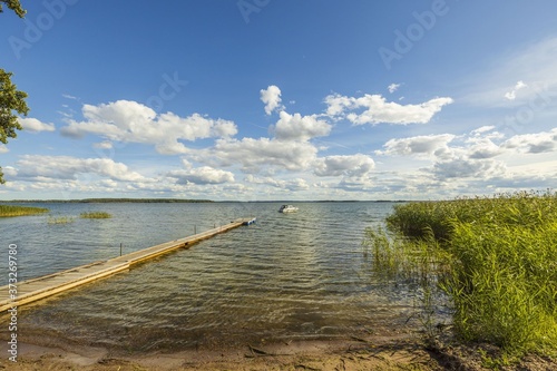 Wallpaper Mural View of  Baltic Sea with  boat parked in shore on blue sky background. Beautiful backgrounds of nature landscape. Torontodigital.ca