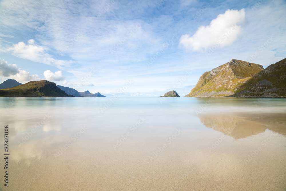 Scenic Haukland beach with reflection on Lofoten Islands in Norway on a bright summer day