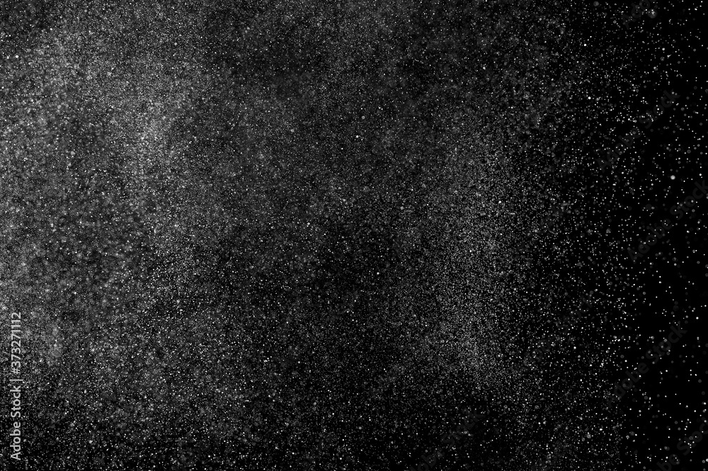Abstract splashes of water on black background. Freeze motion of white particles. Rain, snow overlay texture. Abstract splashes of water on black background. Freeze motion of white particles. Rain, snow overlay texture.