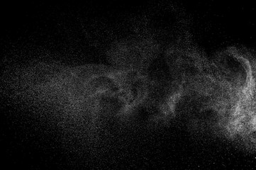 Abstract splashes of water on black background. Freeze motion of white particles. Rain, snow overlay texture.