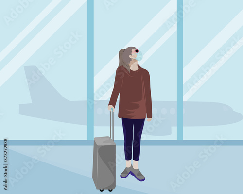 woman wearing a mask to prevent infection.Stand with a suitcase at the airport. concept safe travel in new normal
