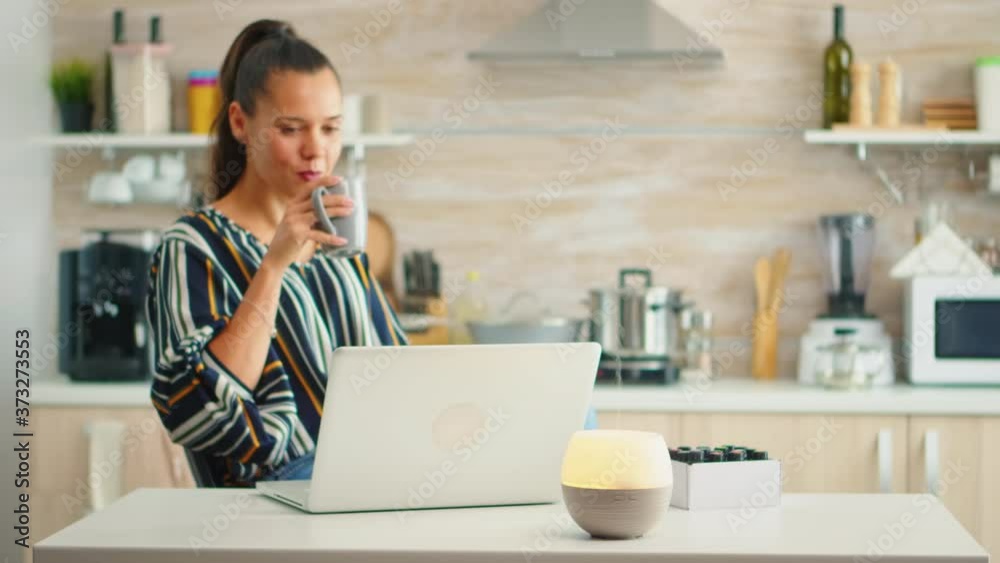 Working in the kitchen with essential oils diffuser steaming. Aroma health essence, welness aromatherapy home spa fragrance tranquil theraphy, therapeutic steam, mental health treatment