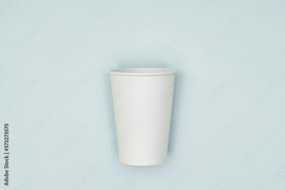 Paper cup in hand on a colored background. Eco-friendly materials in a coffee shop, biodegradable disposable tableware. Close up. Paper cup in hand on a colored background. Eco-friendly materials in a coffee shop, biodegradable disposable tableware. Close up.
