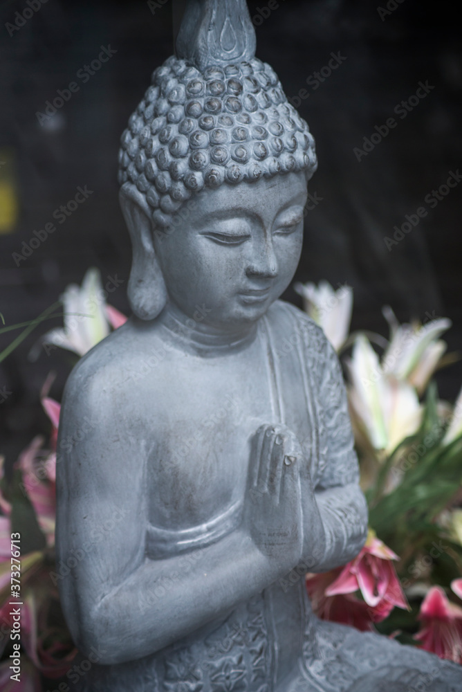 Closeup of stoned buddha statue in a decoration store showroom