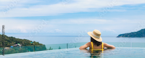 Asian travel bikini woman relax in infinity pool on phuket beach Thailand © Peera