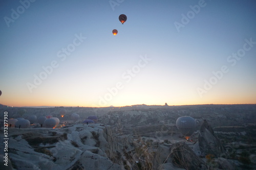 Hot air balloon flying over rock landscape at Cappadocia Turkey