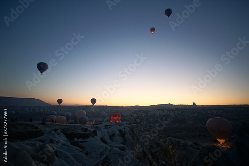 Hot air balloon flying over rock landscape at Cappadocia Turkey