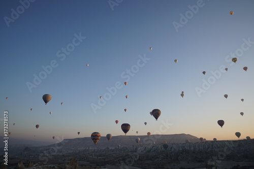 Hot air balloon flying over rock landscape at Cappadocia Turkey