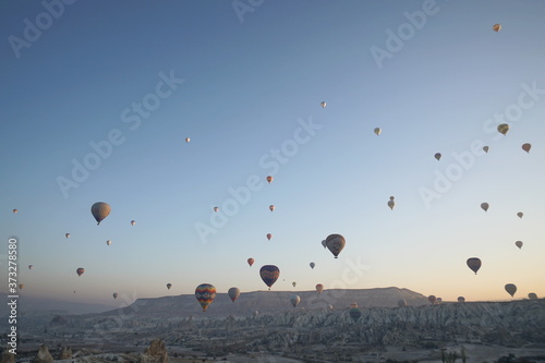 Hot air balloon flying over rock landscape at Cappadocia Turkey