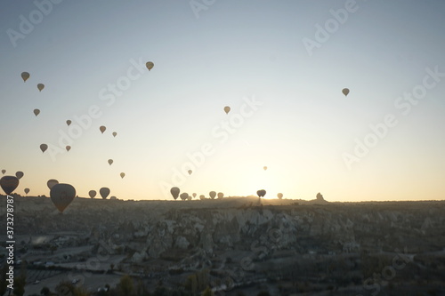 Hot air balloon flying over rock landscape at Cappadocia Turkey © Hirotsugu