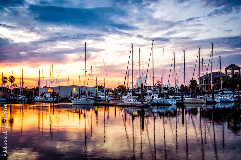 Fresh morning marina sunrise with sailboats and calm water 
