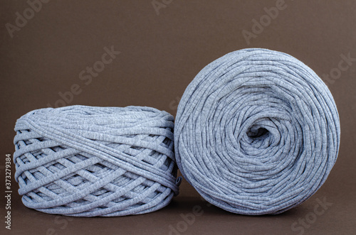 t-shirt yarn balls light gray color on brown background. Handmade craft recycle eco concept
