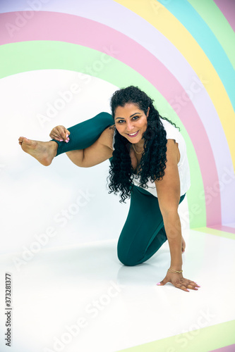 young and beautiful woman in a yoga pose photo