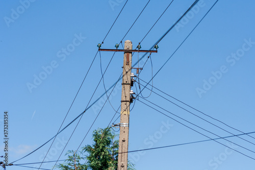 Old energy pole with four line in Poland. Electricity price concept background