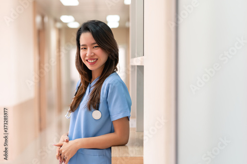 Free Download Asian doctor woman portrait. female doctor or nurse wearing a uniform and stethoscope working in hospital. - GFXLoad
