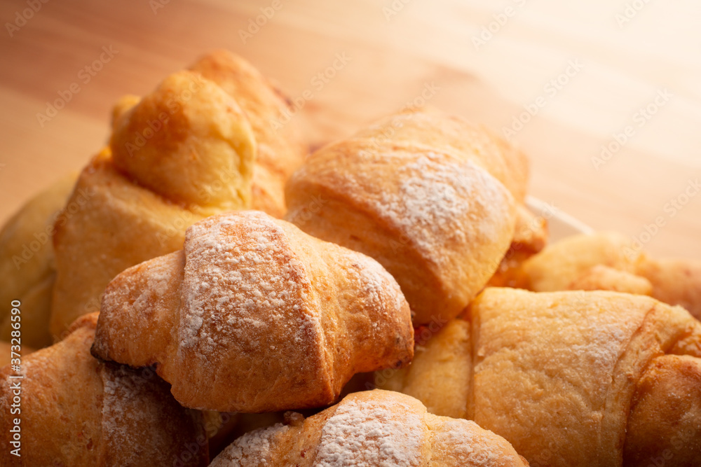 Fresh tasty croissants in plate of wooden table Fresh tasty croissants in plate of wooden table