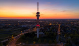 Antenna tower in city sunset