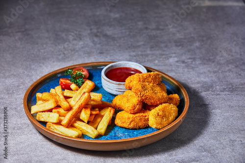 Chiken Nuggets with French Fries and Ketchup.