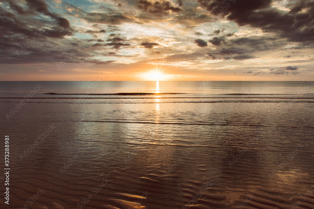 The golden hour morning sea when the sun just rises and the sea still darkens on a calm day. The golden hour morning sea when the sun just rises and the sea still darkens on a calm day.
