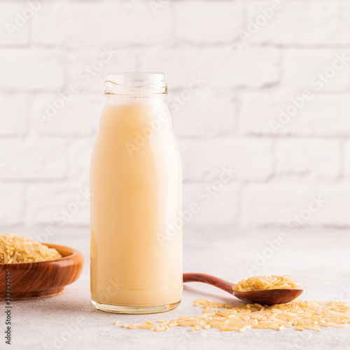 A bottle of rice milk and rice. photo