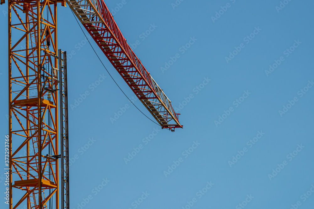 Red and white boom of a construction crane. Red and white boom of a construction crane.