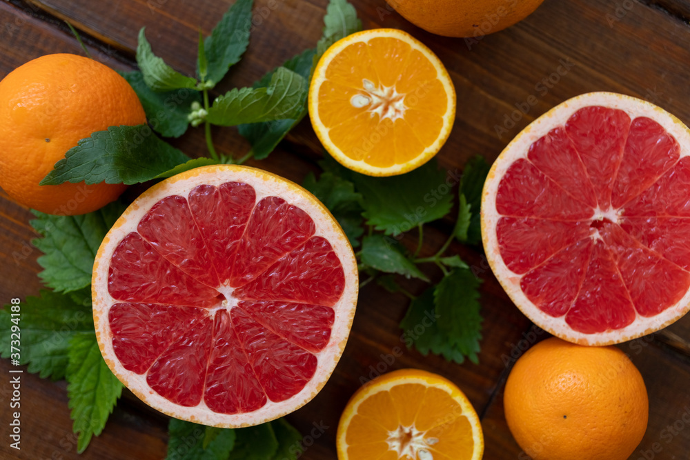 oranges and grapefruit on a brown wooden background, top view, text space, citrus oranges and grapefruit on a brown wooden background, top view, text space, citrus