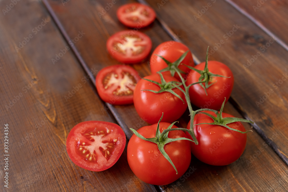 tomato on a brown wooden background, top view, text space, fresh vegetables tomato on a brown wooden background, top view, text space, fresh vegetables