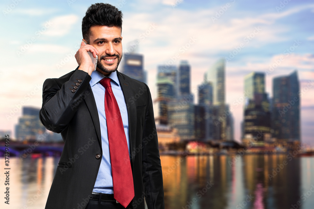 Smiling businessman talking at the phone Smiling businessman talking at the phone