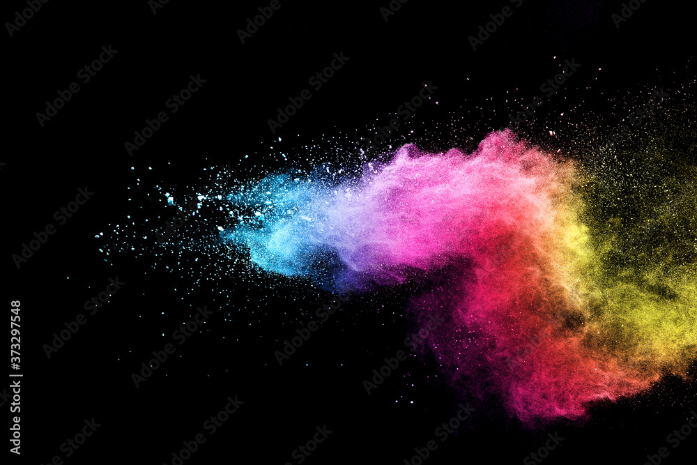 Fototapeta Explosion of colored powder isolated on black background.