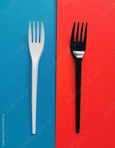 black and white forks on red and blue background