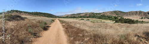 Panoramic view of dry dusty trails in the valley with blue sky, San Diego, California, USA