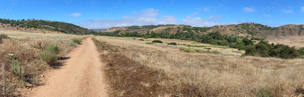 Panoramic view of dry dusty trails in the valley with blue sky, San Diego, California, USA Panoramic view of dry dusty trails in the valley with blue sky, San Diego, California, USA