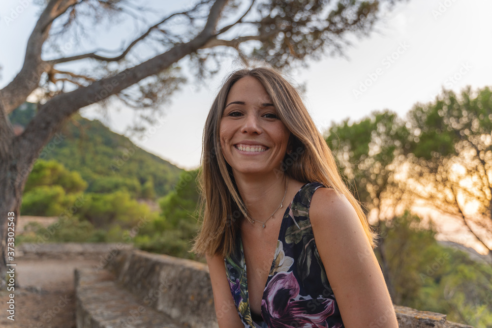 Portrait of a smiling young woman during sunset Portrait of a smiling young woman during sunset