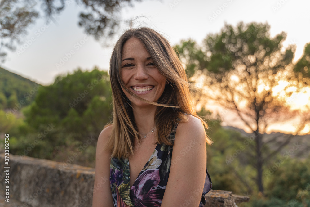 Portrait of a smiling young woman during sunset Portrait of a smiling young woman during sunset