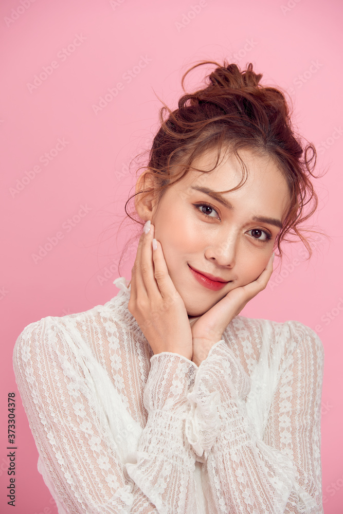 Portrait of beautiful woman on pink background