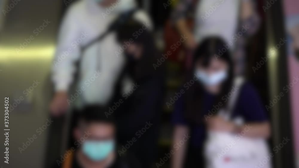 4K, Blurred defocused view of Taiwaneses travellers wear mask at entrance escalator of metro station to prevent infection coronavirus. The virus has caused emergency situation arround the world-Dan 4K, Blurred defocused view of Taiwaneses travellers wear mask at entrance escalator of metro station to prevent infection coronavirus. The virus has caused emergency situation arround the world-Dan