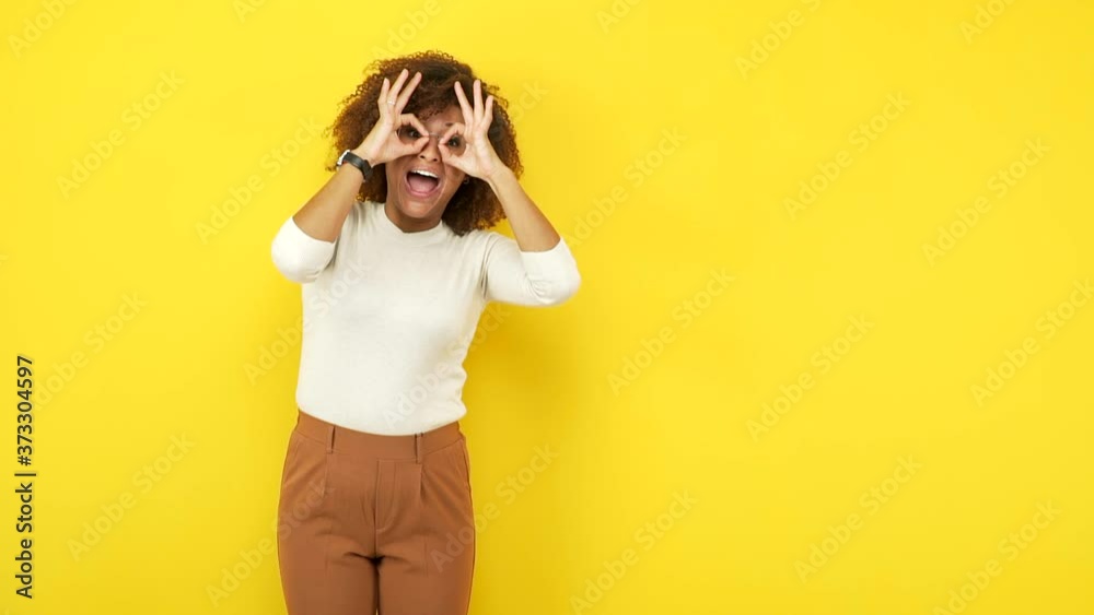 Young african american woman confident doing ok gesture on eye Young african american woman confident doing ok gesture on eye