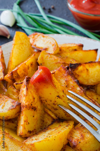 Golden spicy potato wedges fried or oven baked with garlic, ketchup and onion.