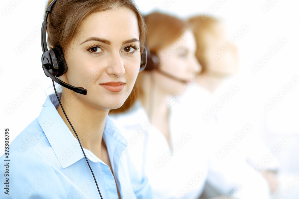 Call center. Focus on beautiful business woman in headset Call center. Focus on beautiful business woman in headset