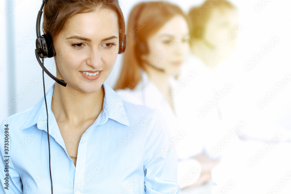 Call center. Focus on beautiful business woman in headset Call center. Focus on beautiful business woman in headset