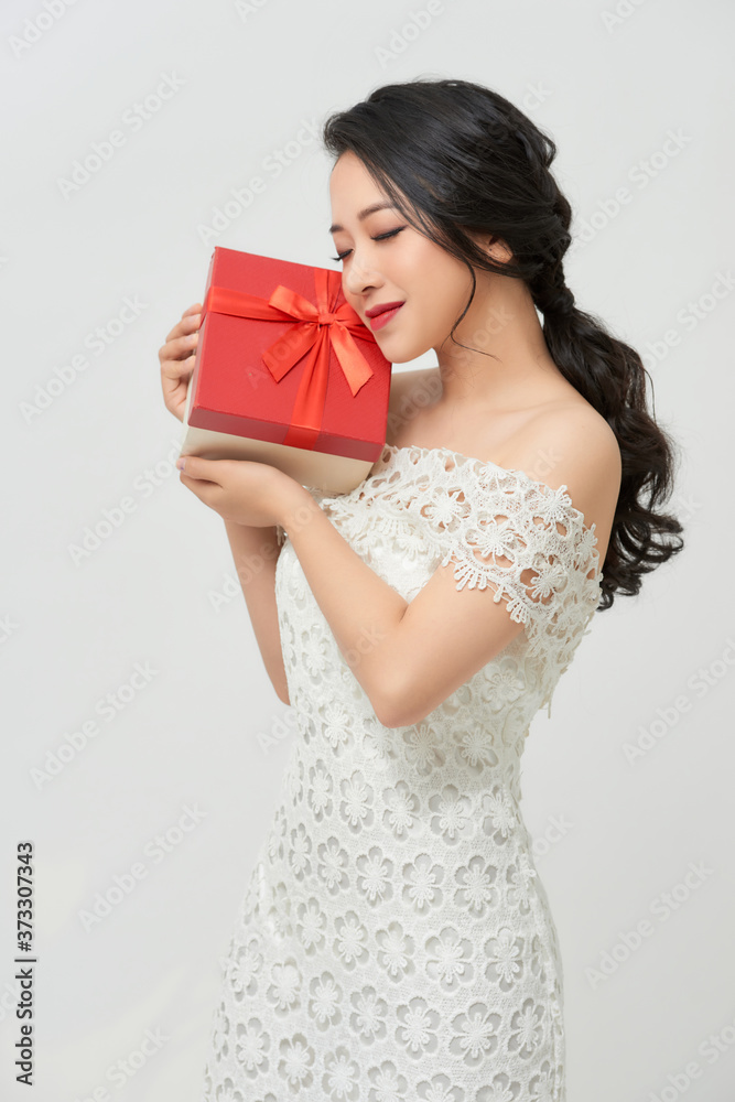 holidays, presents, wedding and happiness concept - smiling woman in white dress holding red gift box holidays, presents, wedding and happiness concept - smiling woman in white dress holding red gift box