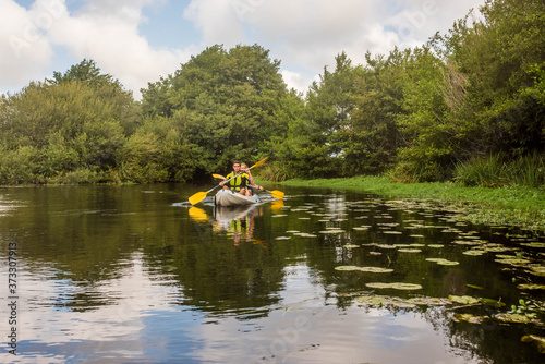 young couple kayaking down the river